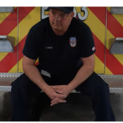 A firefighter sitting on a truck