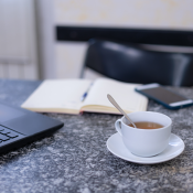 a coffee cup and computer on a desk